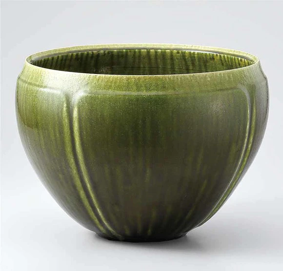 Flower vessel with green glaze.