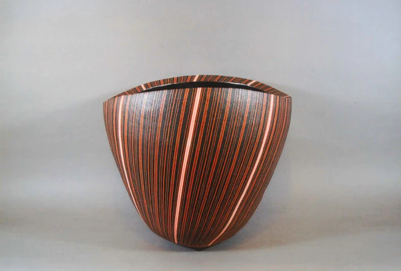 Vessel with stripe design on black background