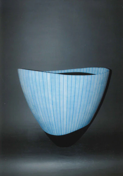 Vessel with hazy blue glaze and stripe pattern