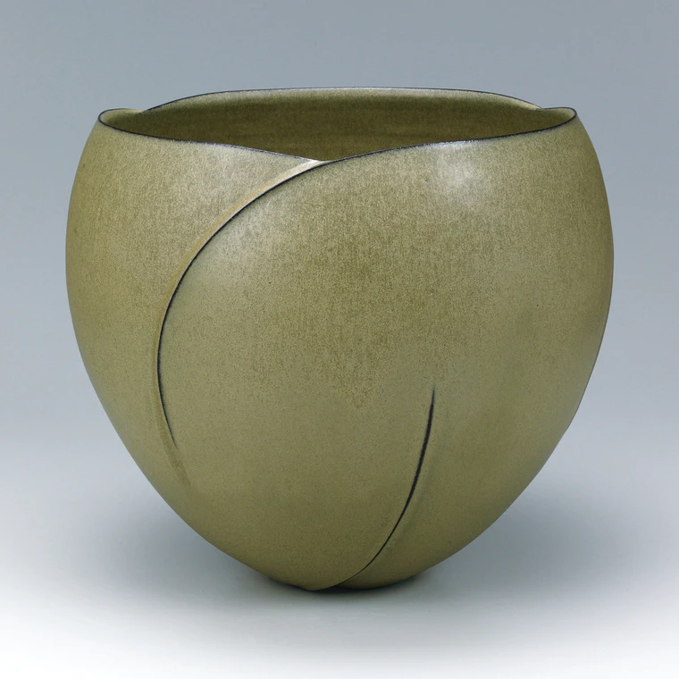 photo Flower vessel with “fallen leaf” color glaze and curved line design.