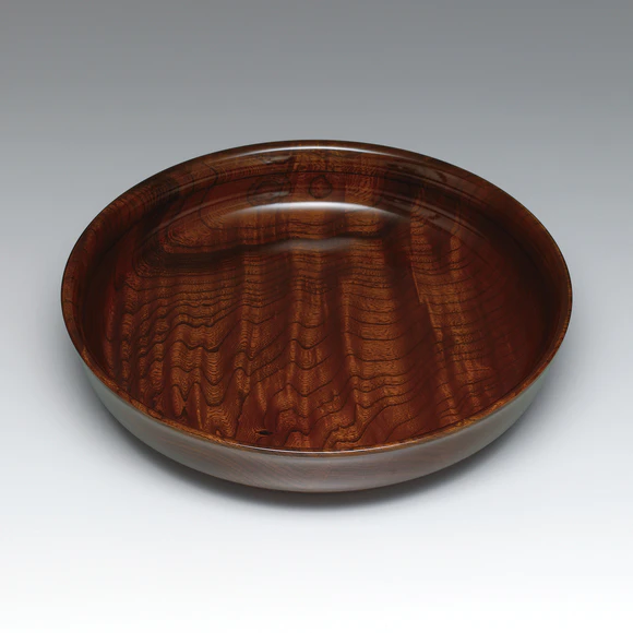 Vessel of zelkova wood finished in wiped urushi.