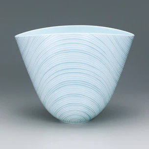 White porcelain warped bowl with pale blue glaze, engraved linear decoration and glaze inlay. “Ren”