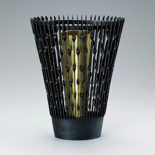 Forged iron flower vessel with twisted line design.
