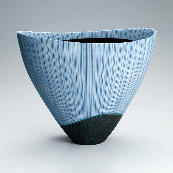 Vessel with hazy blue glaze and stripe pattern.