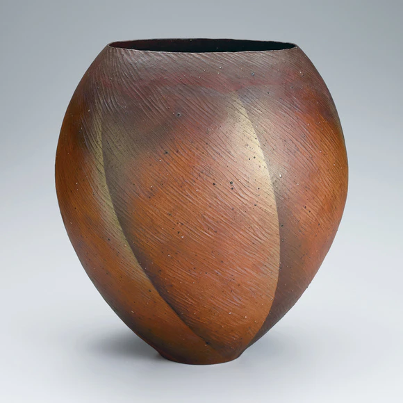Jar shaped by beating and decorated with colored clay.