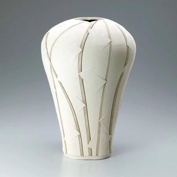 Jar of irregular shape with colored slip decoration.