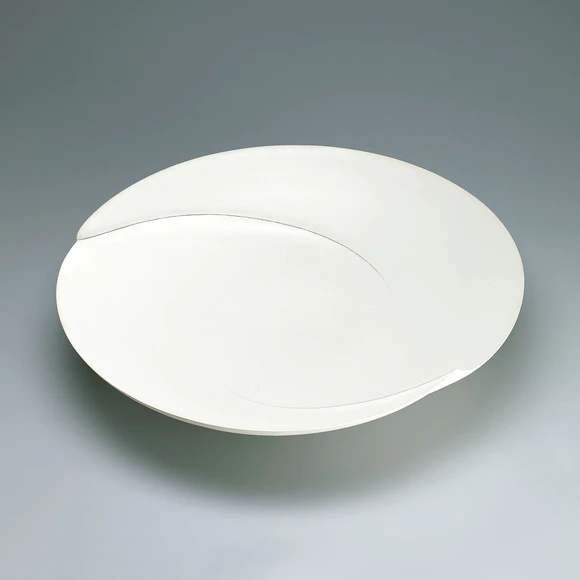 Dish with white glaze and ridged line design.