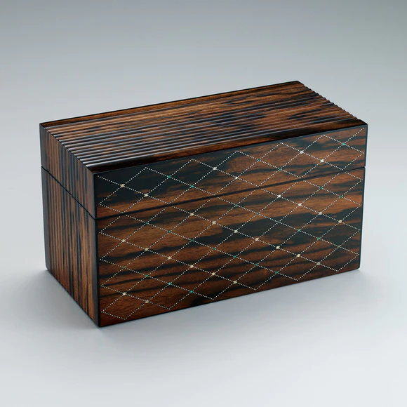Box of black persimmon wood with inlay decoration finished in wiped urushi.
