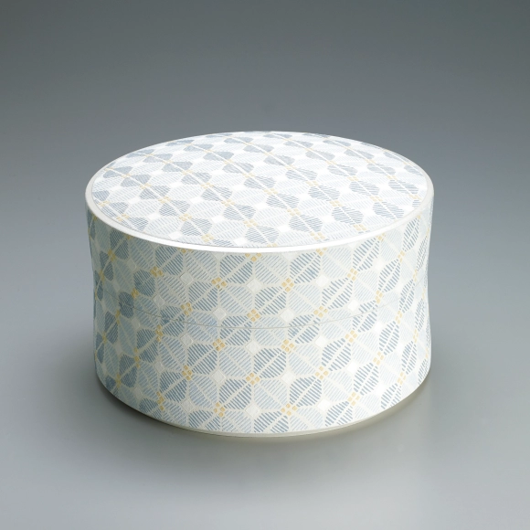 Box with connected patterns in cut paper stencil.
