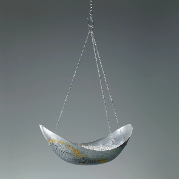 Boat shaped silver hanging flower vessel. “Across the sea”