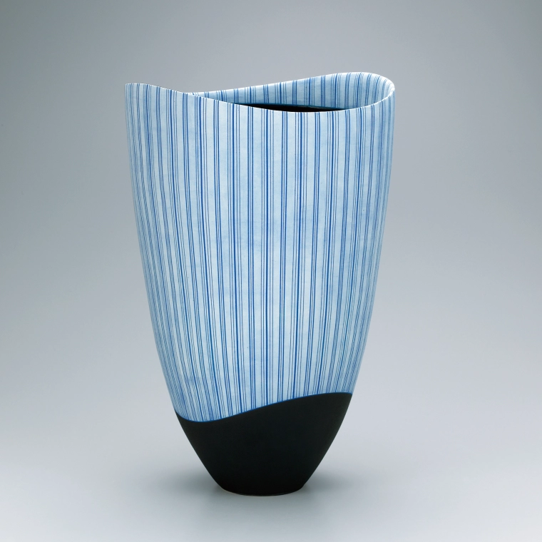photo Vessel with hazy blue glaze and stripe pattern.