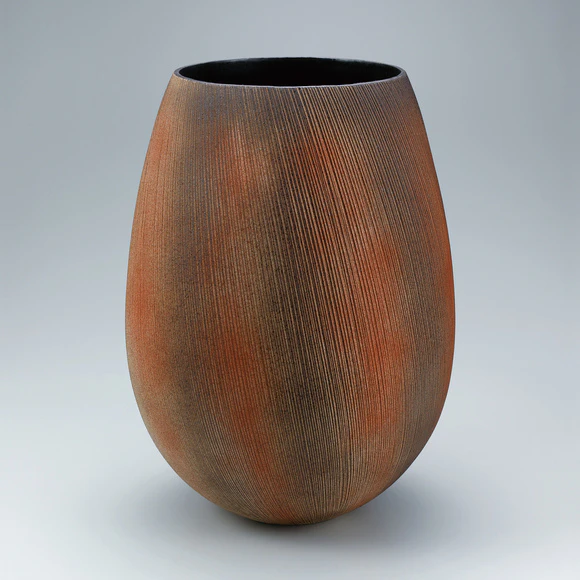 Flower vessel with line design in colored slip.