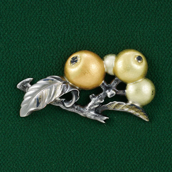 Metal fitting in shape of loquat.