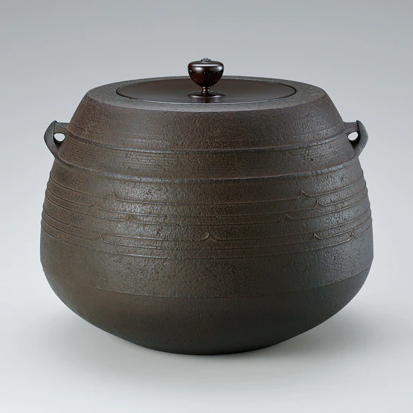 Tea ceremony kettle of “caved-in mouth” type with line design.