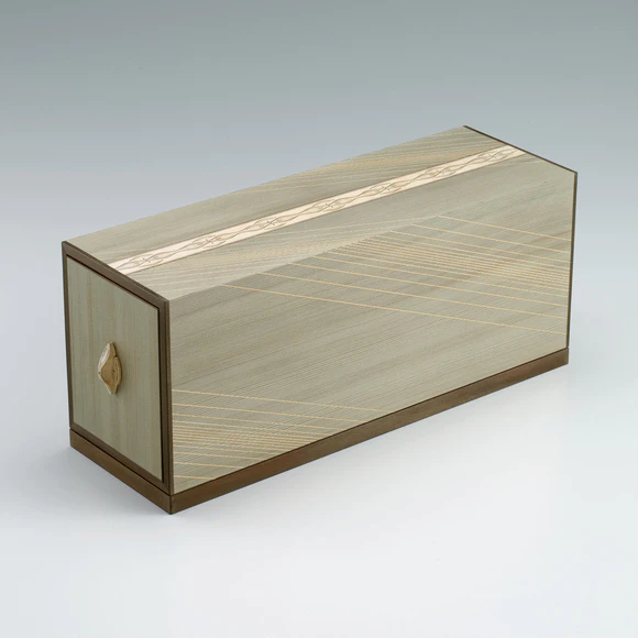Portable box of drawers made of jindai zelkova wood open at both ends with floral diamond design.