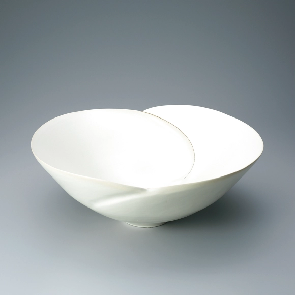 Bowl with white glaze and ridged line design.