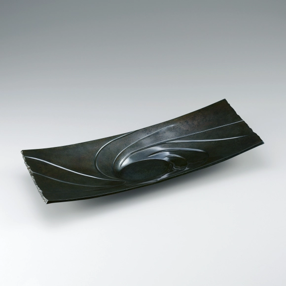 Plate of rōgin cast in lost wax casting method. “Suck”