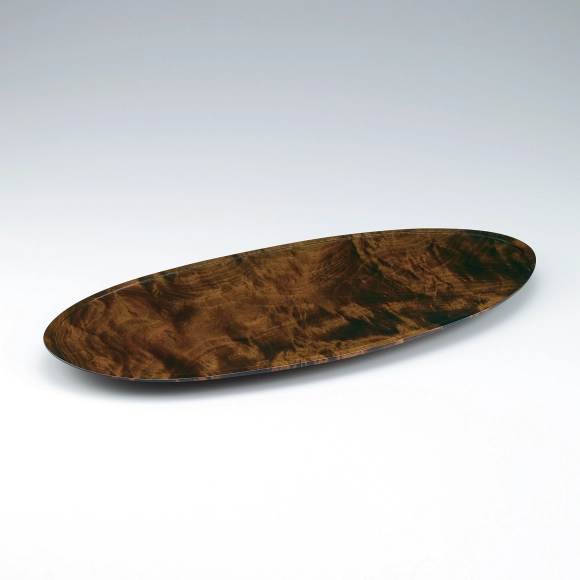 Oval vessel of horse chestnut wood finished in wiped urushi.