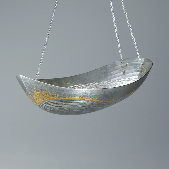 Boat shaped silver hanging flower vessel. “Departure from the port”
