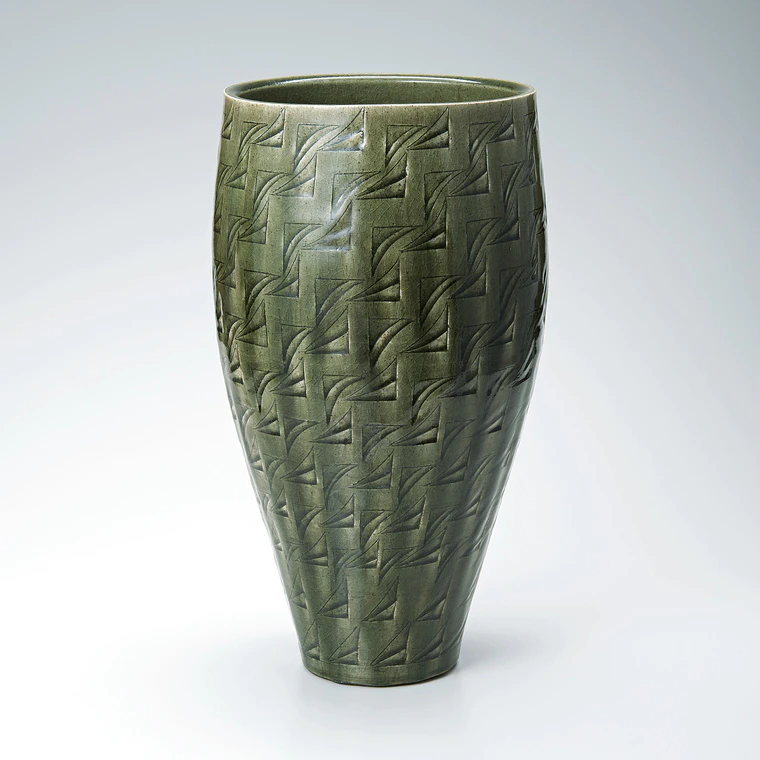 photo Flower vessel with ash glaze and engraved design.