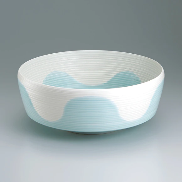 Bowl with line design in colored glaze.
