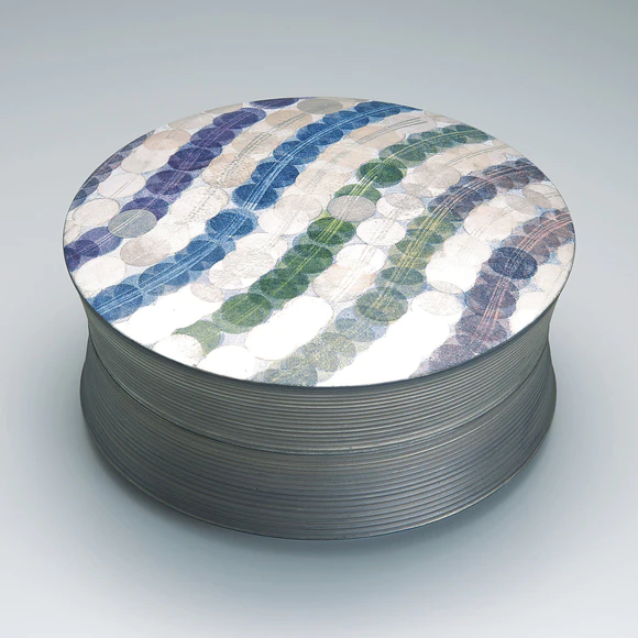 Round box with wave design in overglaze enamel and silver.