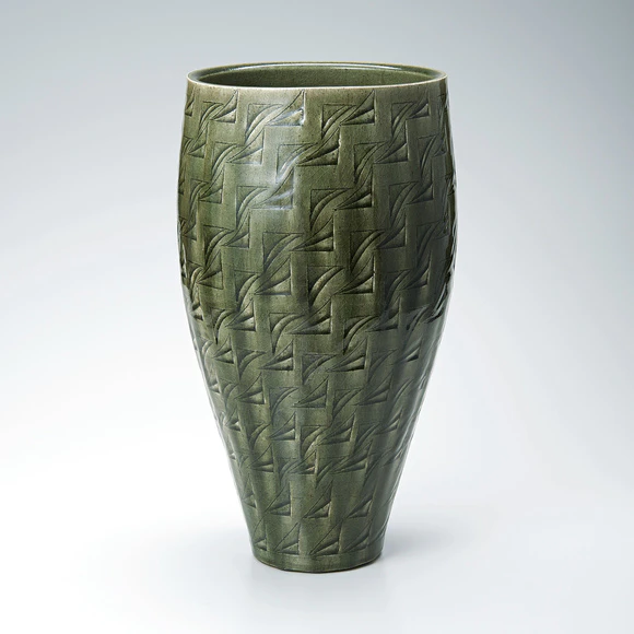 Flower vessel with ash glaze and engraved design.