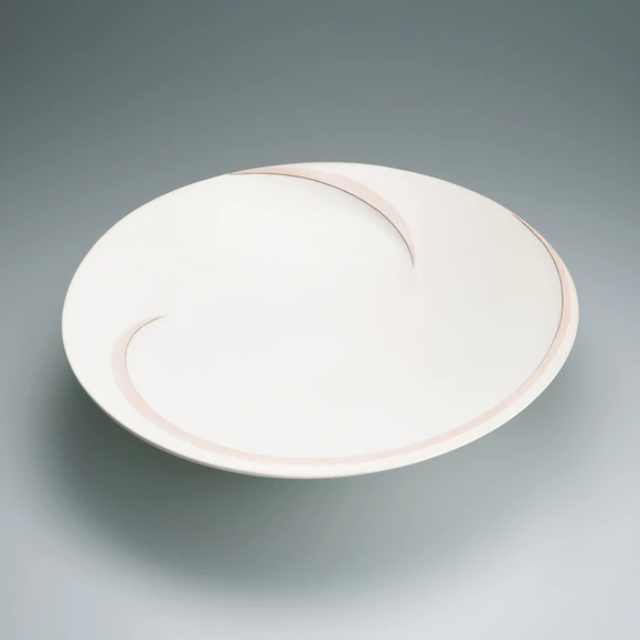 Bowl with white glaze and ridged line design.