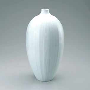 White porcelain jar with pale blue glaze and line design.