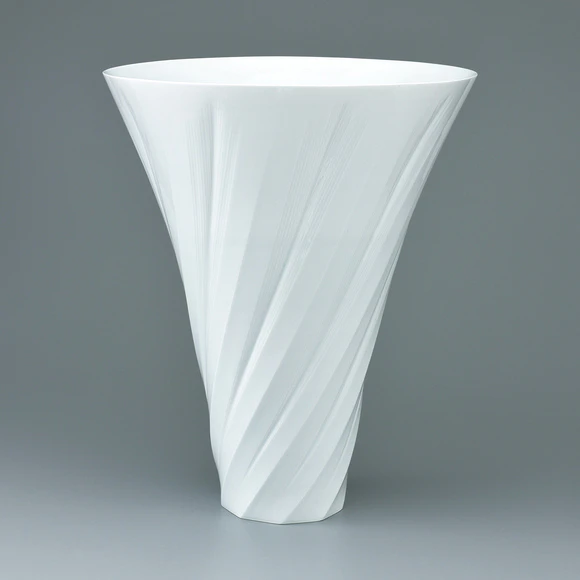 White porcelain faceted flower vessel with engraved line decoration.