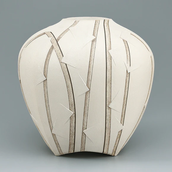 Jar in irregular shape with colored slip decoration.