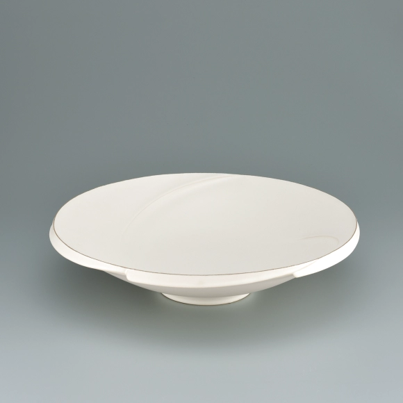 Bowl with white glaze and ridged line design.