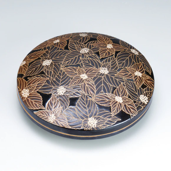 Covered vessel with iron glaze and hydrangea design.