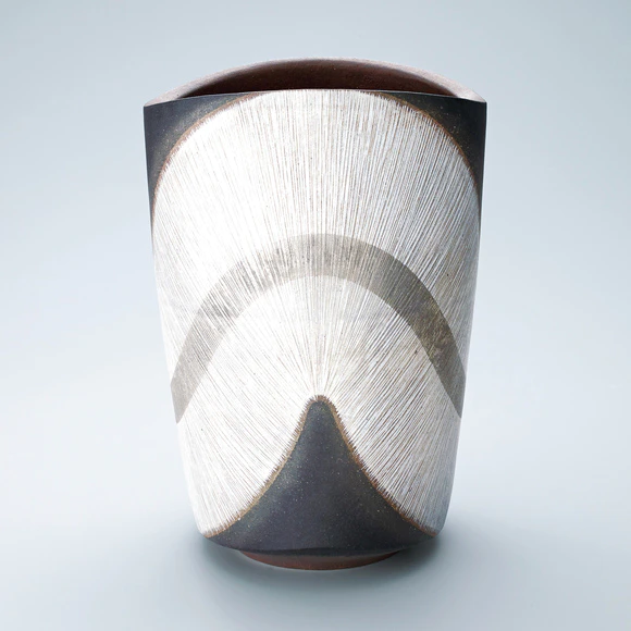 Vessel with engraved line design and platinum painting.