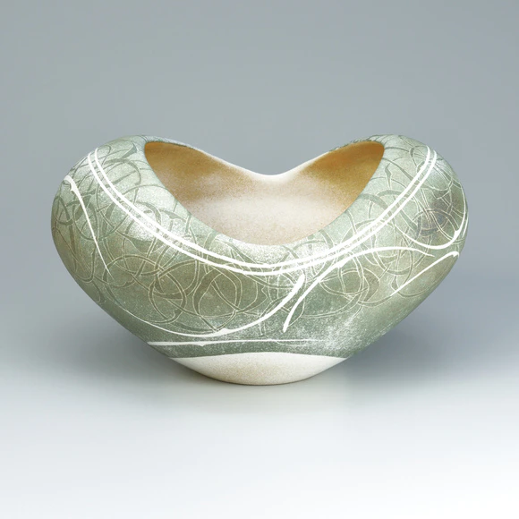 Flower vessel with lotus and circle design in colored slip.