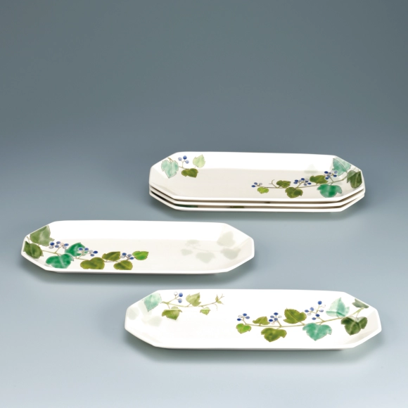 Set of oblong dishes with porcelain vine design in overglaze enamel.