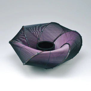 Flower vessel of bamboo in varying colors. “Eddying current”