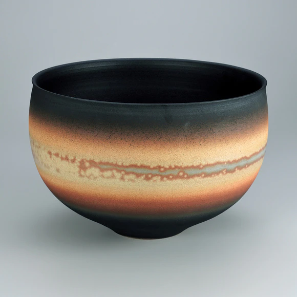 Flower vessel with glaze in kakewake style and kiln mutation effects.