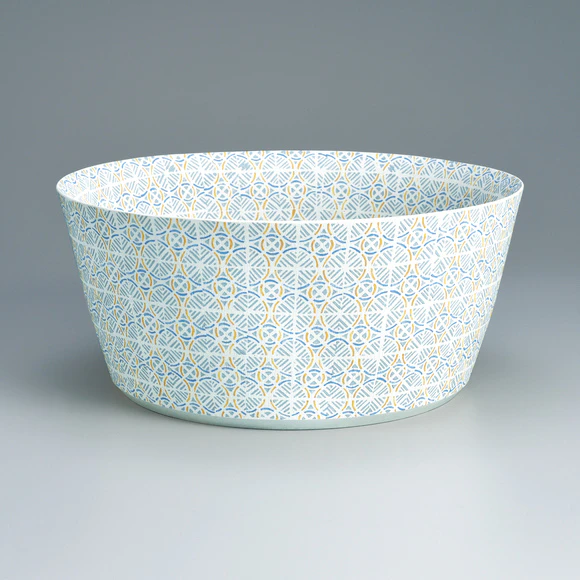 Bowl with wavy line design in joined cut paper stencil.
