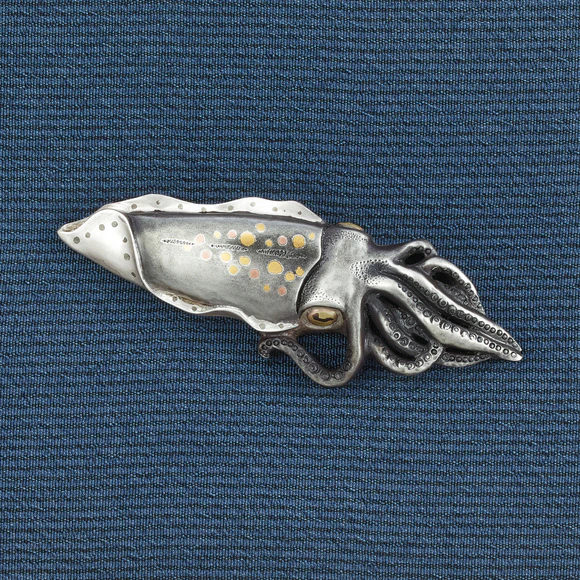 Metal fitting in shape of squid.