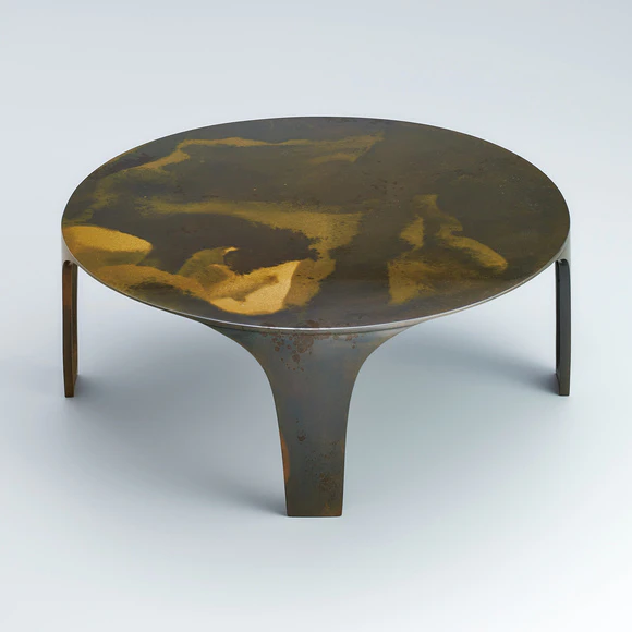 Low round table cast in two different metals.