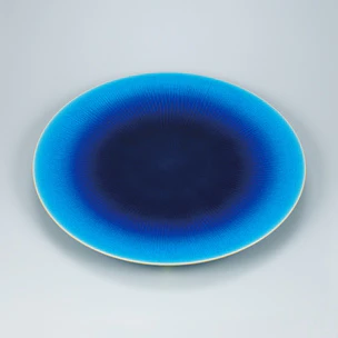 Vessel with blue glaze and ripple design.