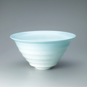 White porcelain bowl with blue glaze and engraved design.