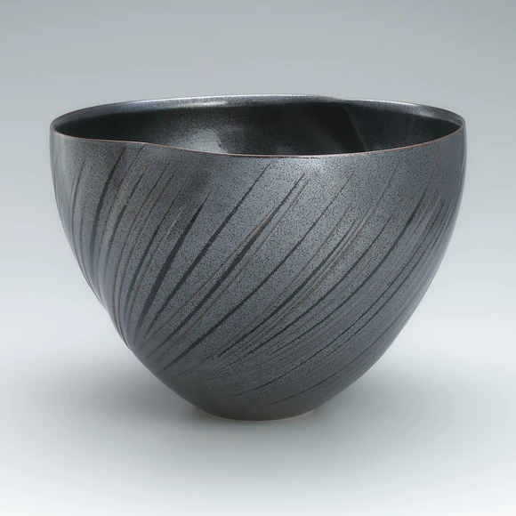 Bowl with tenmoku glaze and engraved line design.
