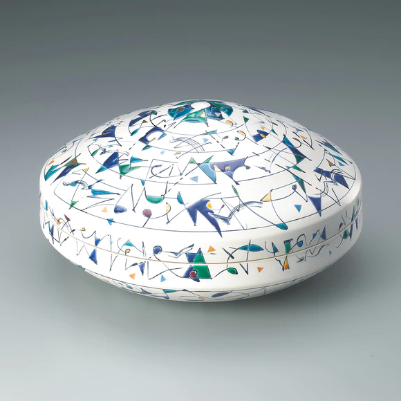 Box with colored geometric design in overglaze enamel.