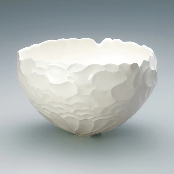 Bowl with curved line design in engraving.