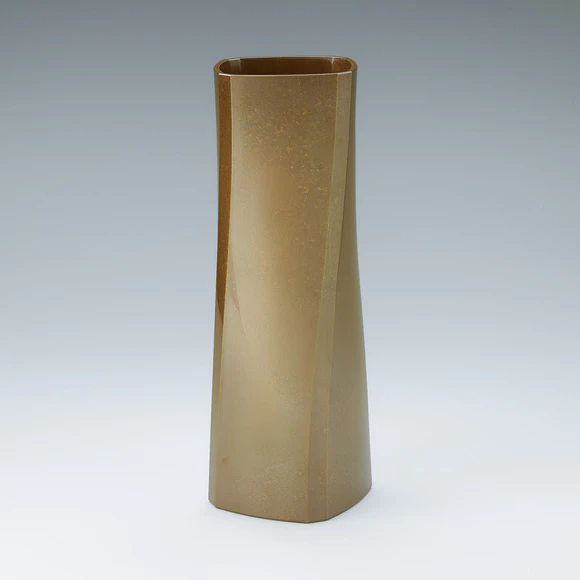 Four faceted flower vessel of brass.