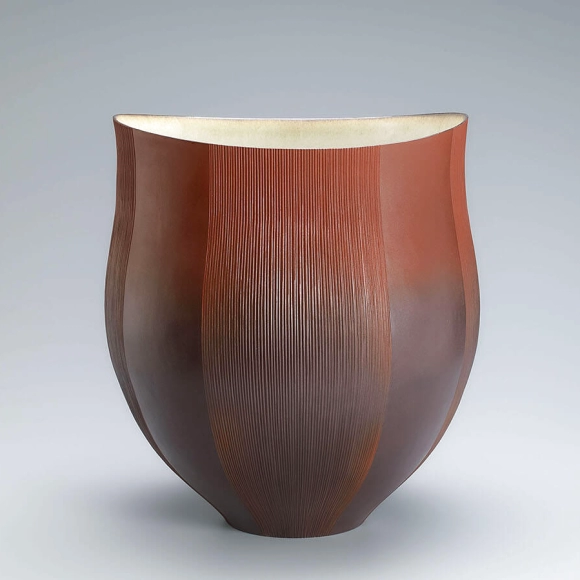 Red flower vessel with line design.