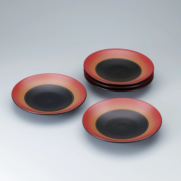 Set of dishes with red glaze, line and chattered pattern design.