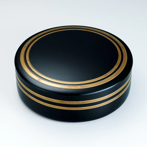 Container for sweets made in bending work with gold decoration.